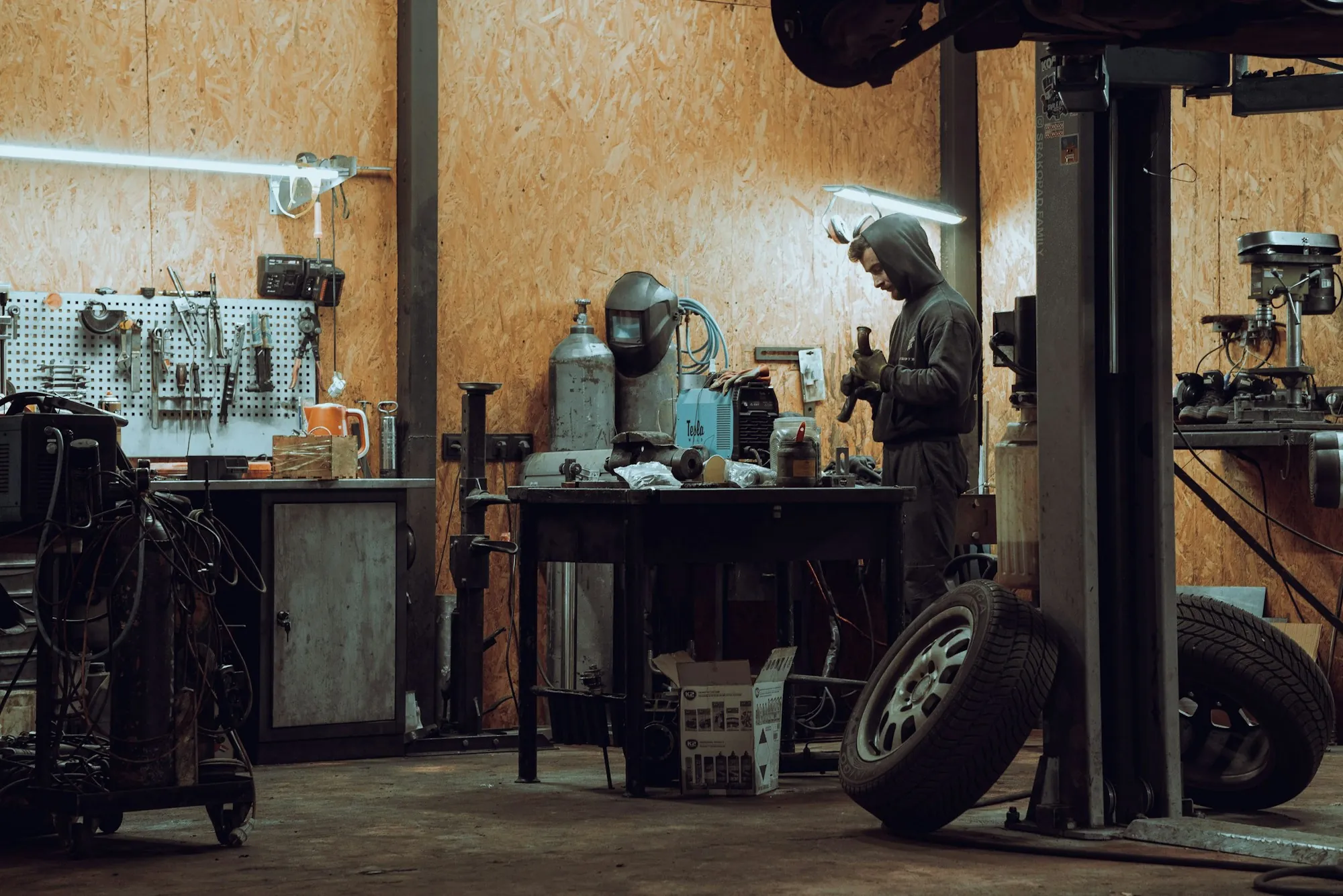 Silver SUV clamped to a frame straightening bench with measuring arms attached underneath