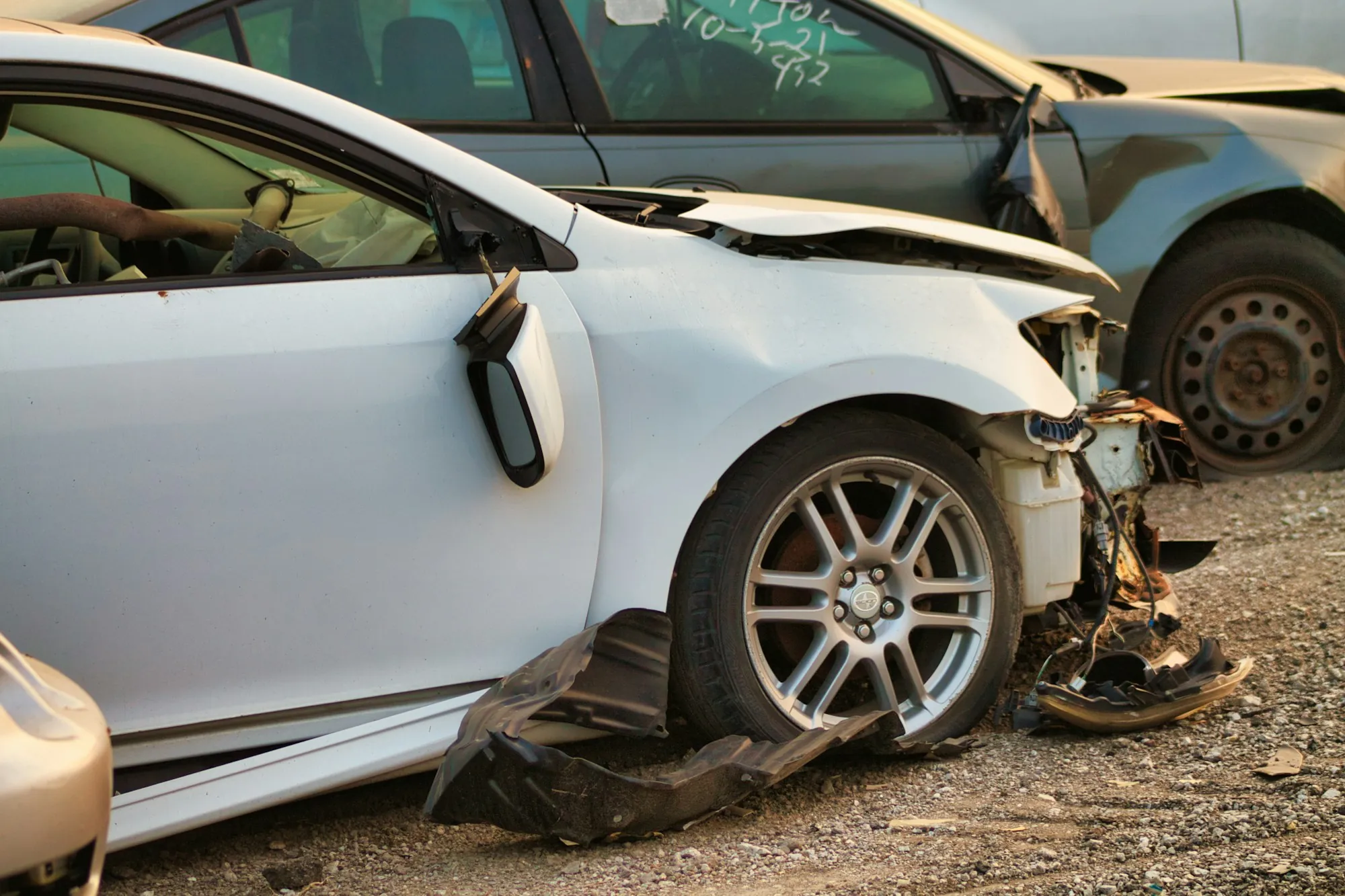 Estimator photographing a damaged rear bumper for a collision claim