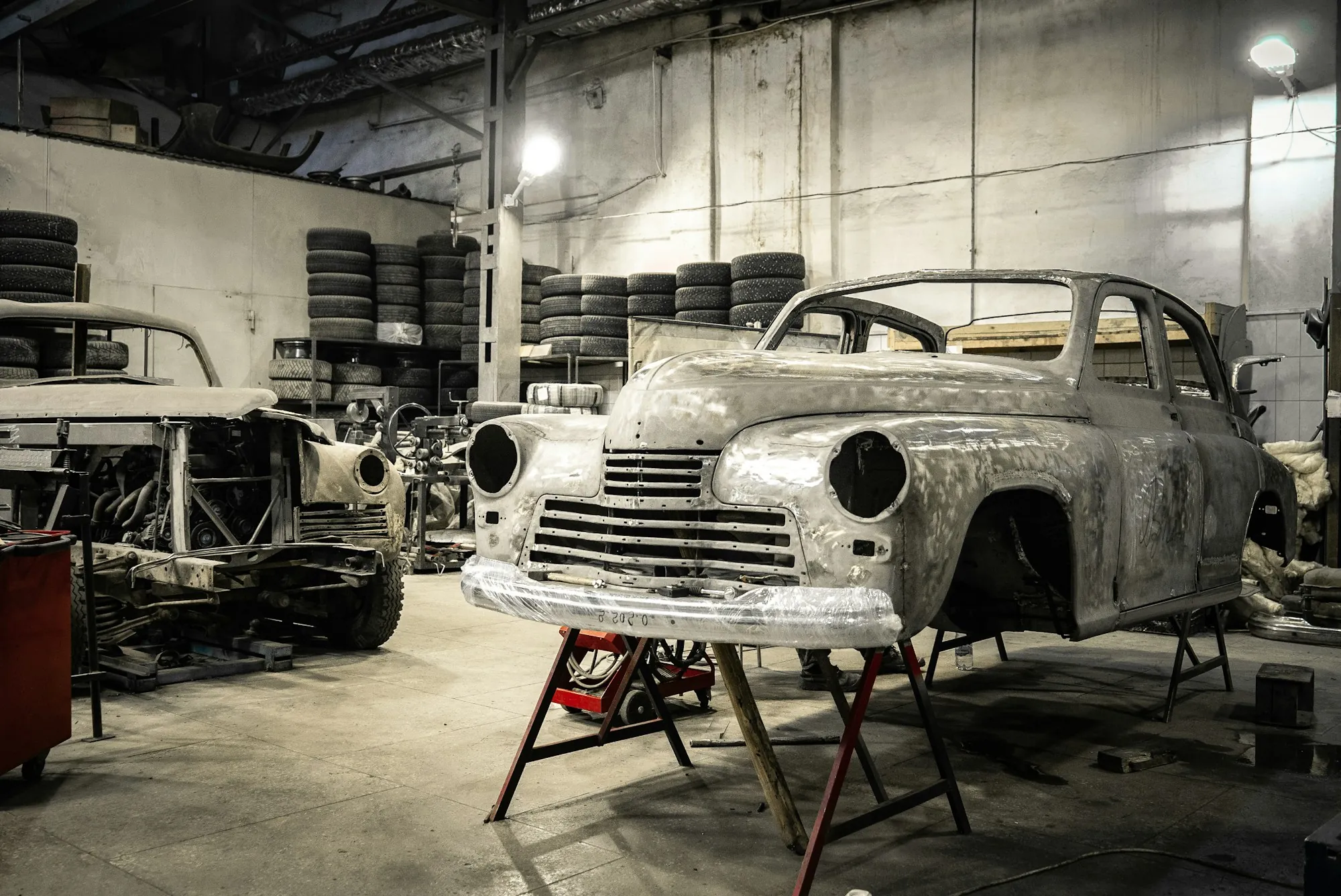 Bare-metal car body being restored in a shop